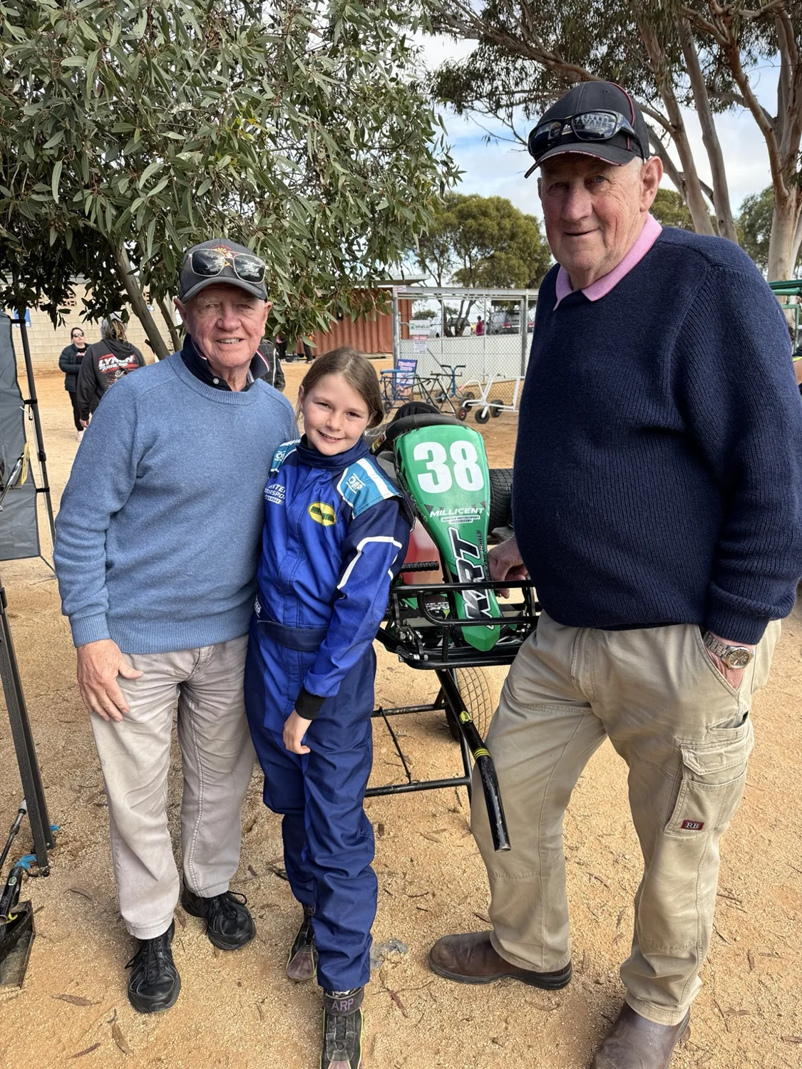 Millicent with her dirt kart and family supporters